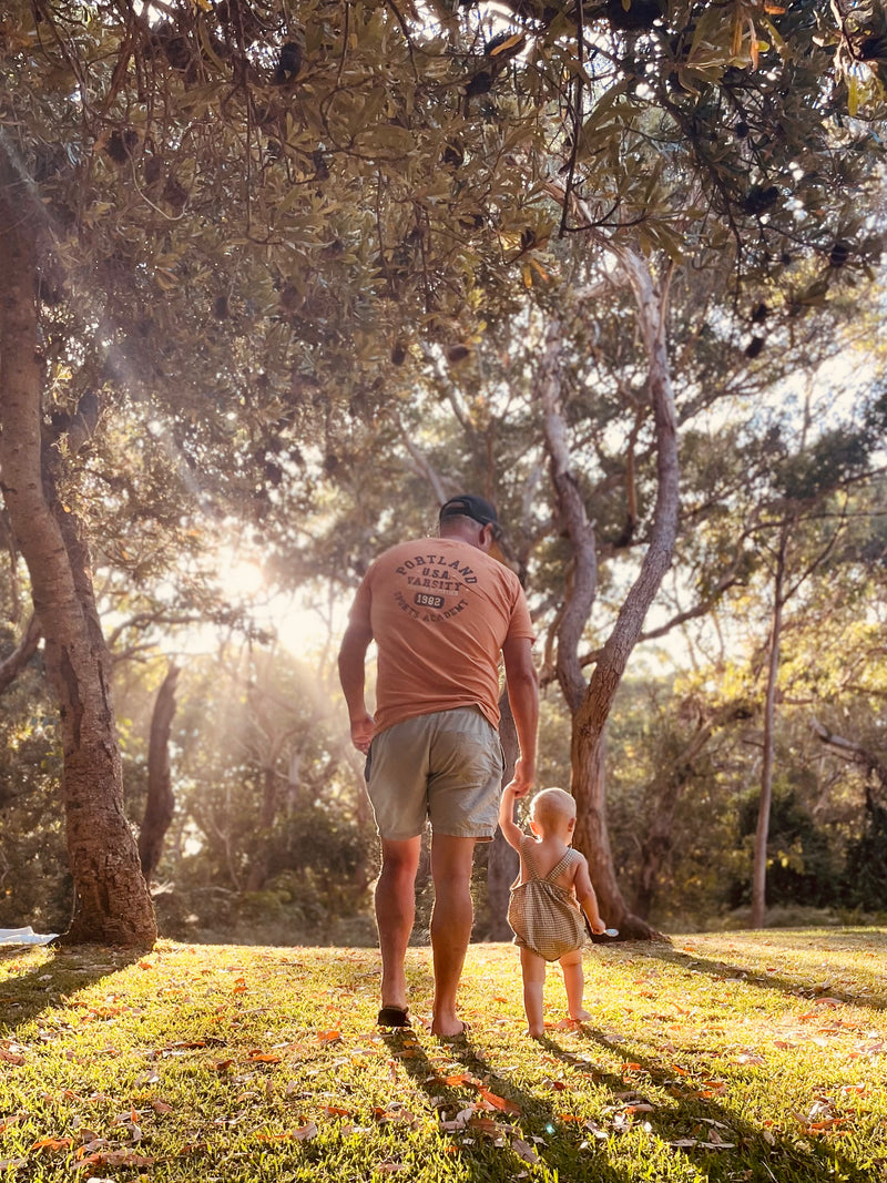 Parent and child walking together through warm afternoon light, reflecting the love and connection that inspired SUNSABI.