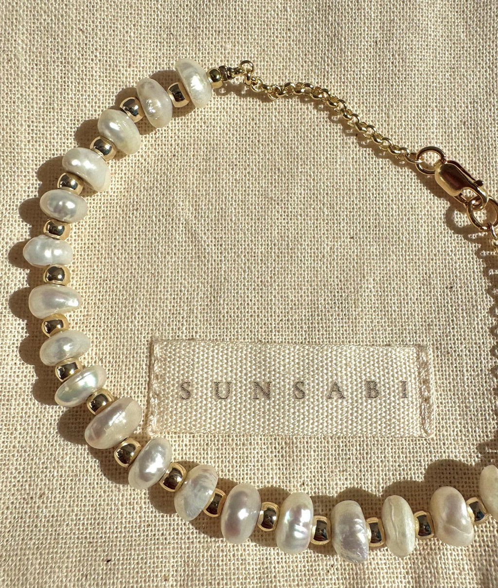 Irregular freshwater pearls and 14k gold-filled spacer beads in the MILESTONES bracelet