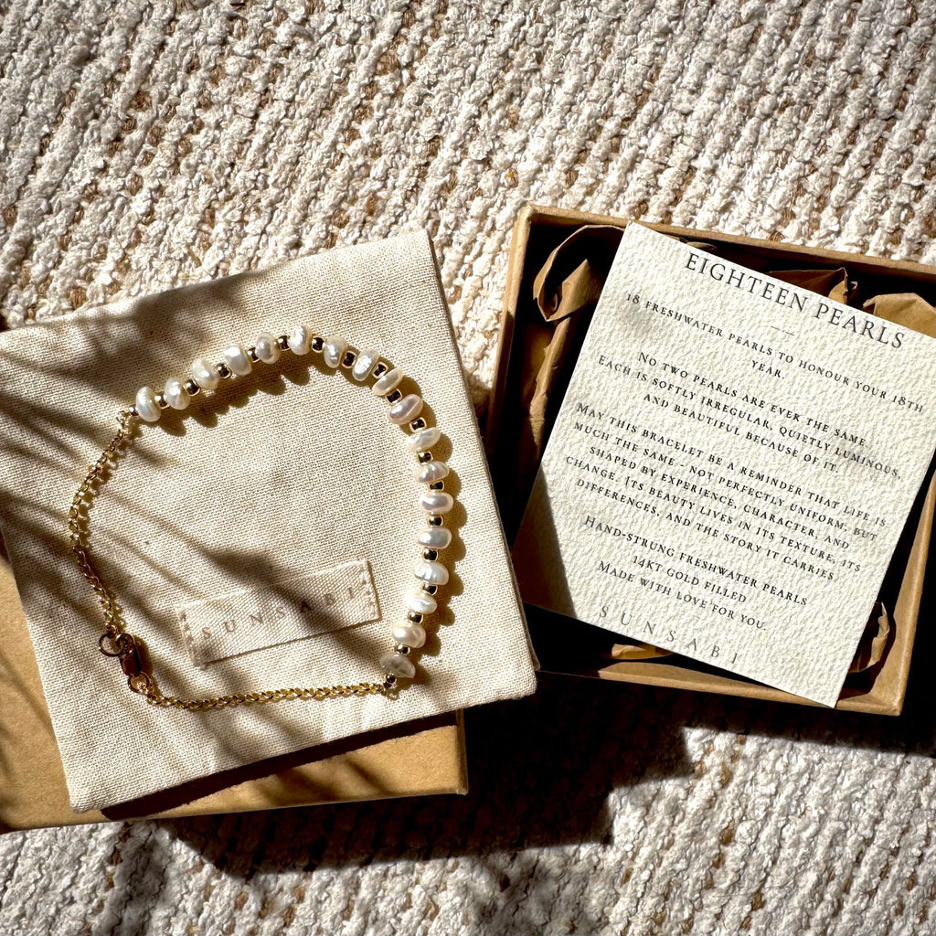 SUNSABI MILESTONES pearl bracelet presented with pouch, box and story card