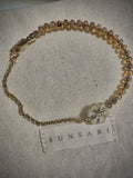 SUNSABI SUN BEAM child bracelet with honey-toned glass beads, Picasso floral glass focal and 14k gold-filled rolo chain