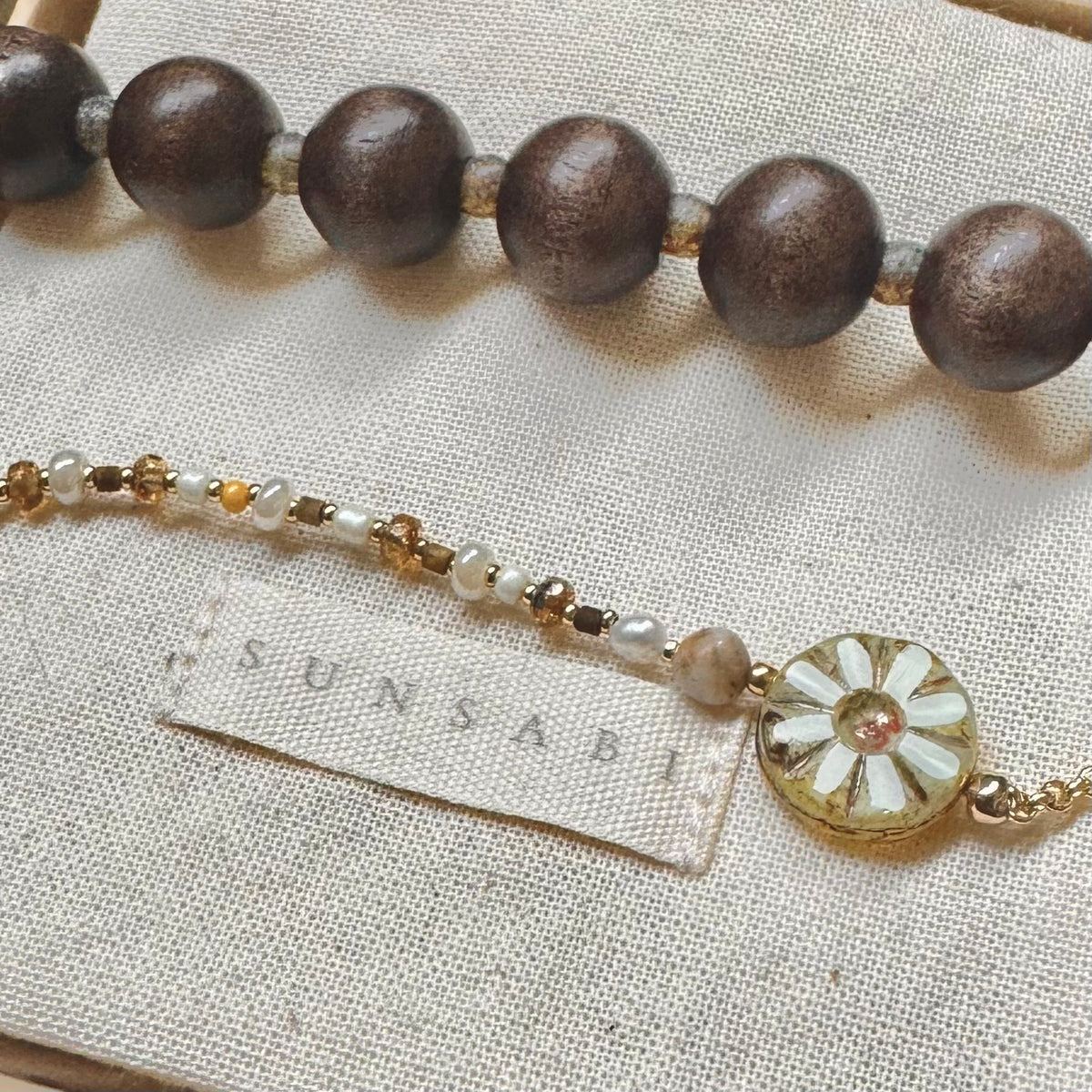 Close-up of SUN BLOOM No. 01 baroque pearl, natural stone and Czech glass floral bead