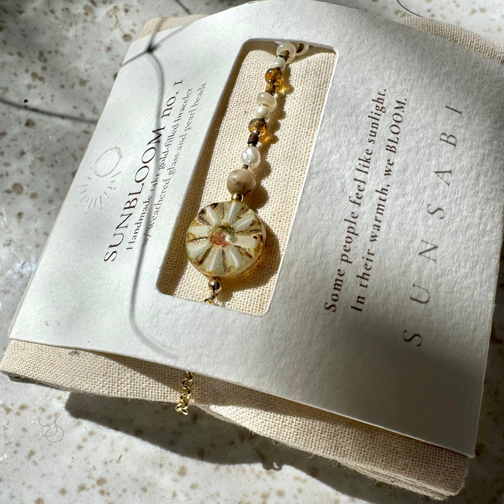 Close-up of SUN BLOOM No. 01 Czech glass bloom, pearl and glass bead details in SUNSABI packaging